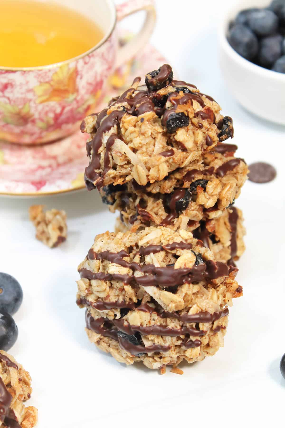 Stack of breakfast cookies with cup of teal.