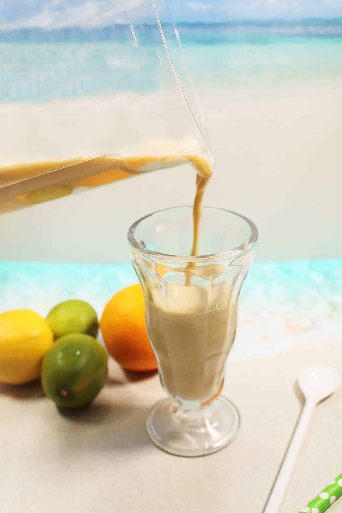 Pouring immune boosting smoothie into glass.