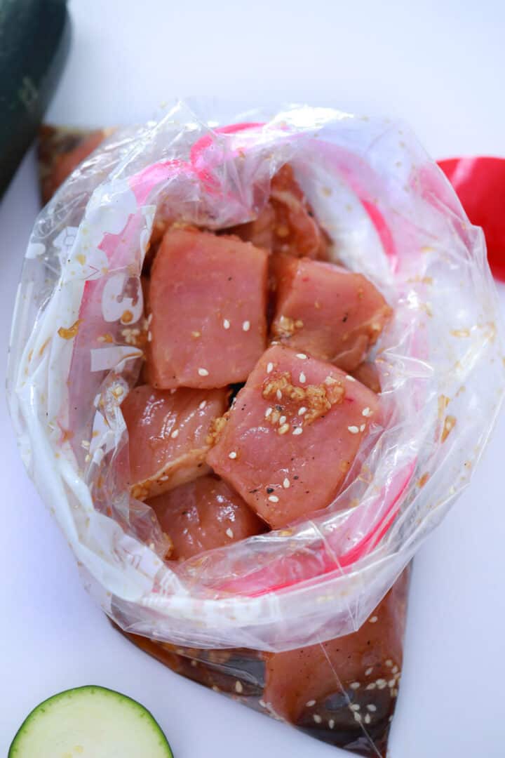 Pork in large ziploc bag with marinade.