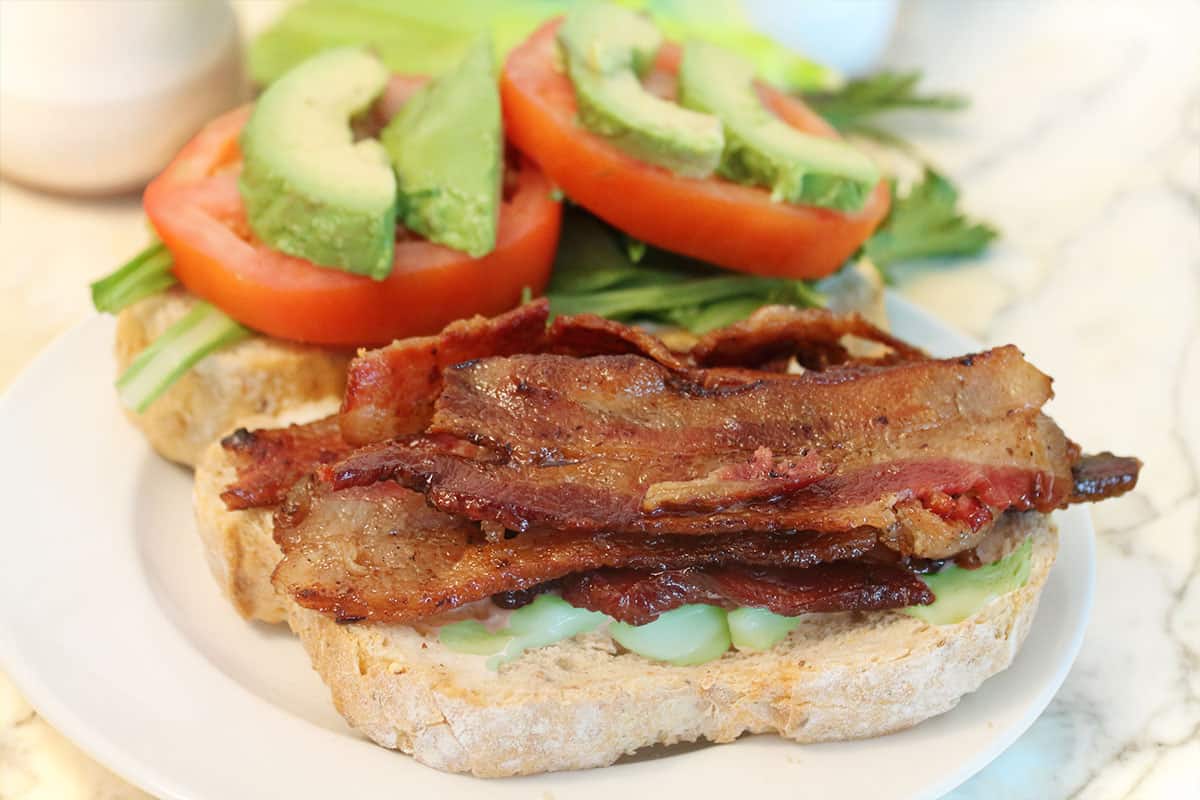 Open-faced Spicy BLT showing avocado and bacon.