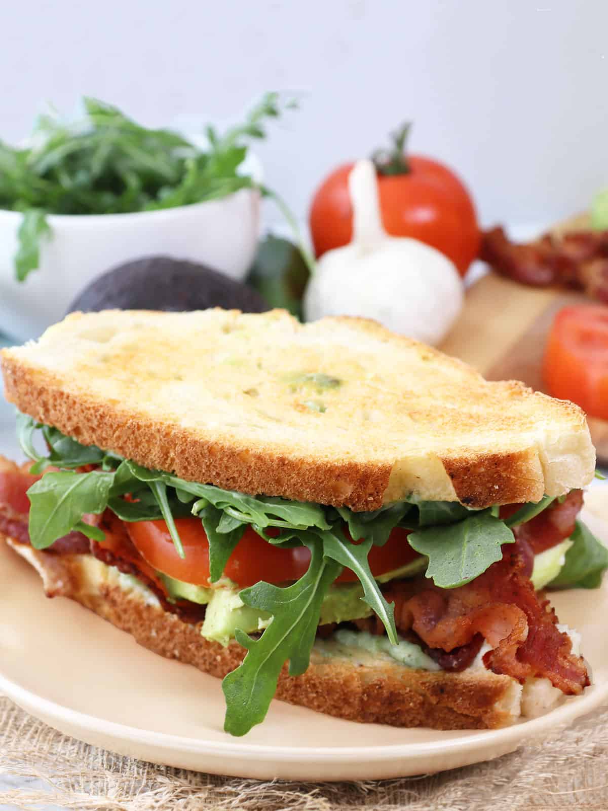 Spicy BLT with avocado and jalapeno mayo plated.