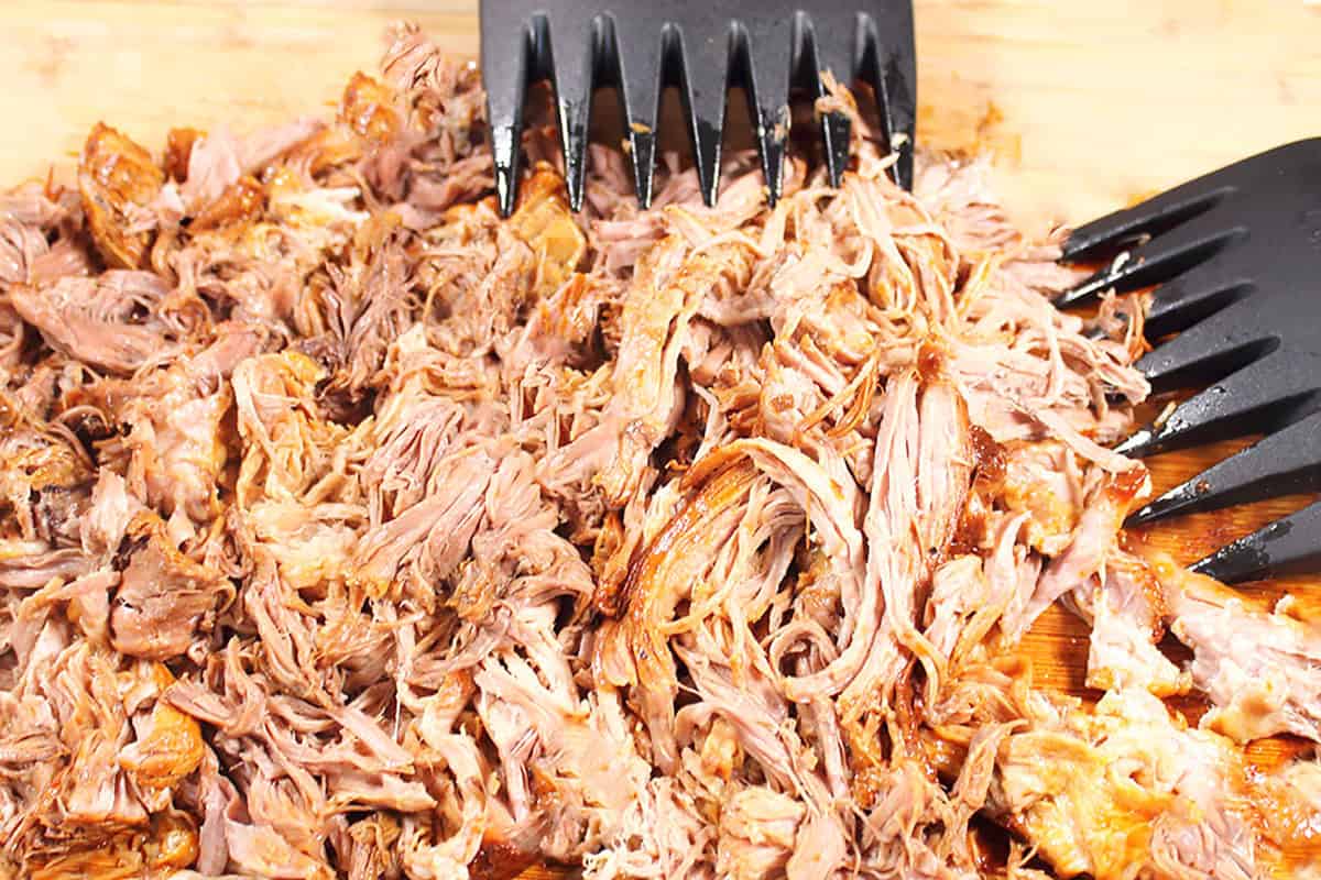 Pulled Cuban pork on cutting board.