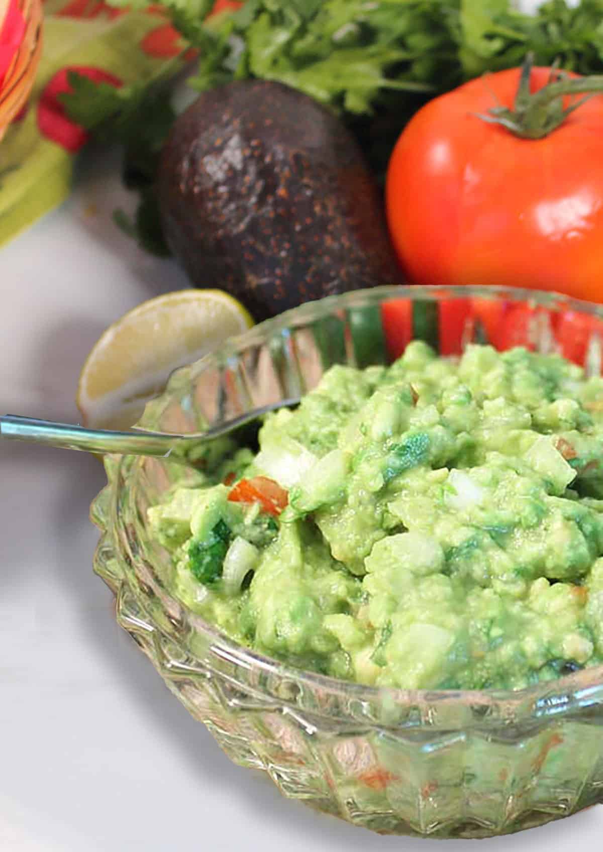 Classic Guacamole with veggies in back.