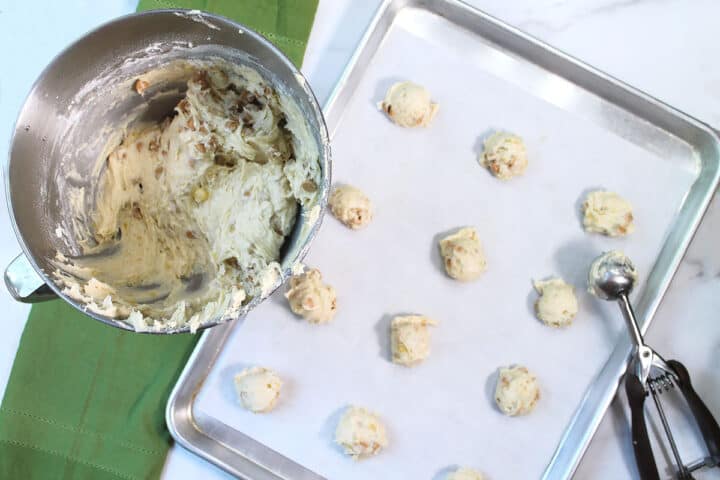 Scooping cookie dough onto cookie sheet.