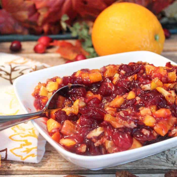 Cranberry orange relish in bowl with spoon.