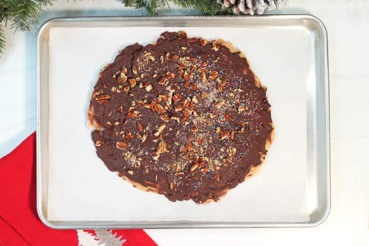 Overhead of chilled chocolate covered toffee on cookie sheet.