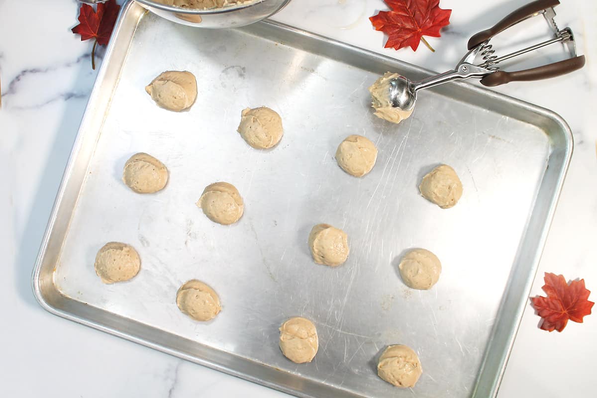 Scooping cookie dough onto cookie sheet.