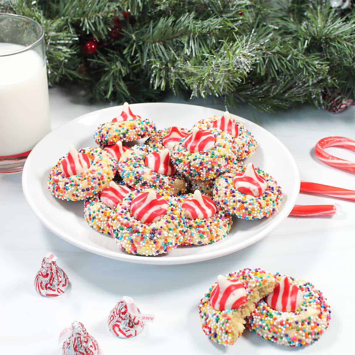 Plated white chocolate peppermint kiss cookies with milk.