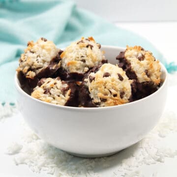 Chocolate dipped macaroons in bowl.