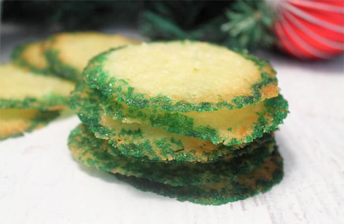 Stacked decorated Coconut Lime Crisps on white table.