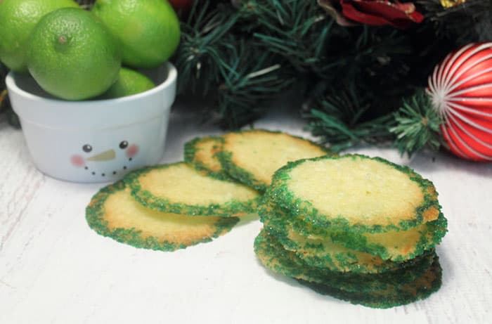 Coconut Lime Crisps on white table with limes in snowman bowl.