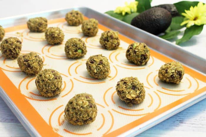 Avocado Oatmeal Chocolate Chip Cookie dough balls on a baking sheet