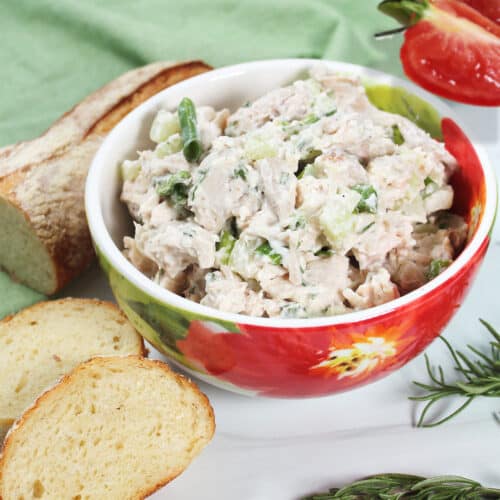 Bowl of chicken salad with rosemary.