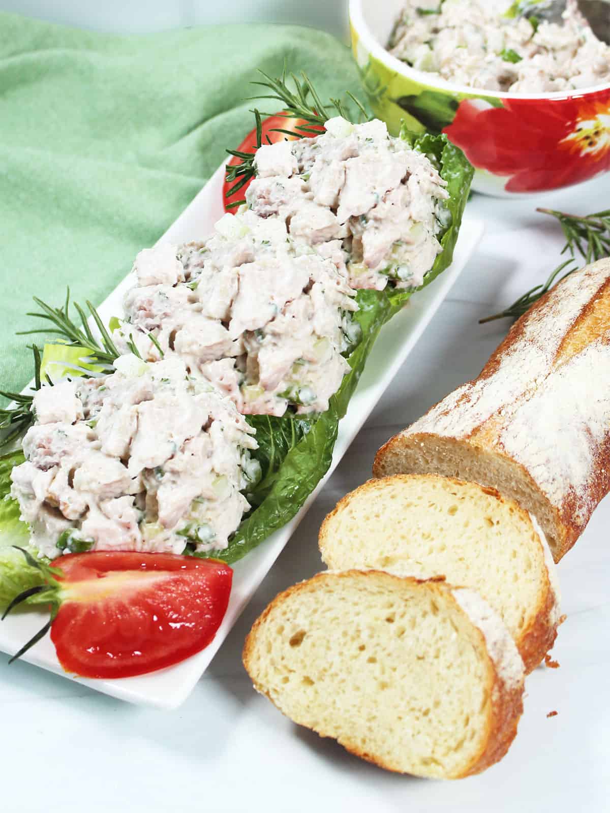 Rosemary Chicken Salad on top of lettuce leaves on platter.