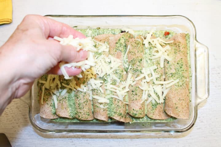 Sprinkling cheese over tortillas.