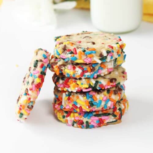 Closeup of stack of cream cheese cookies with one leaning.