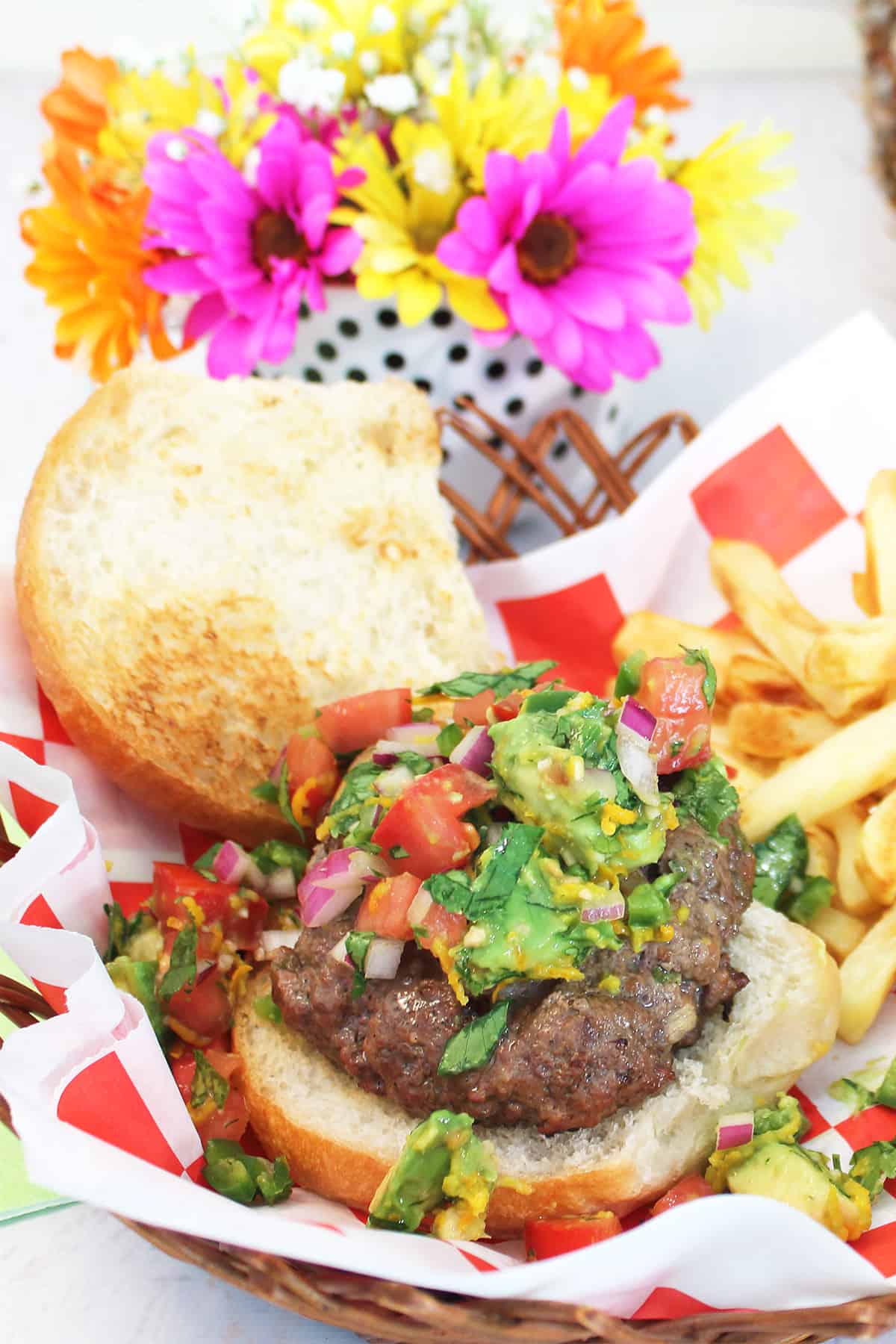 Surf and Turf Burger with cilantro lime salsa and fries in a basket.