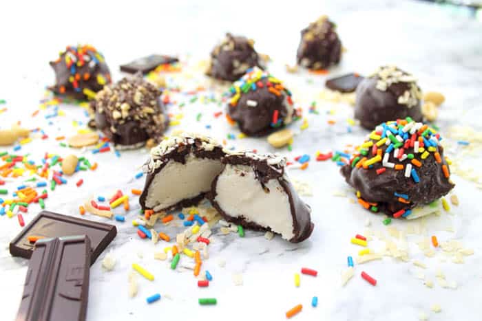 Ice Cream Truffles on white table with chocolate bar.