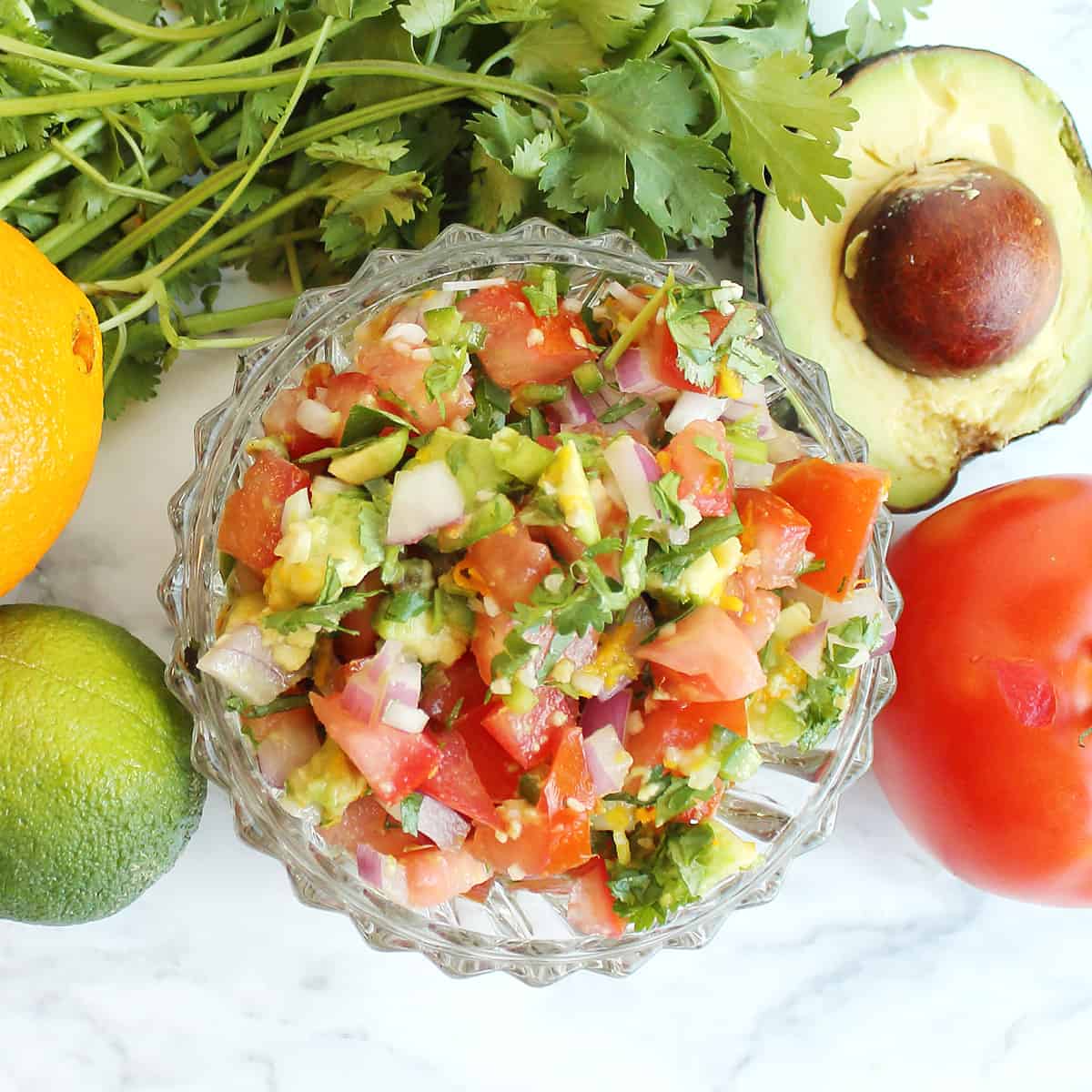 Closeup of lime cilantro salsa with fresh ingredients.