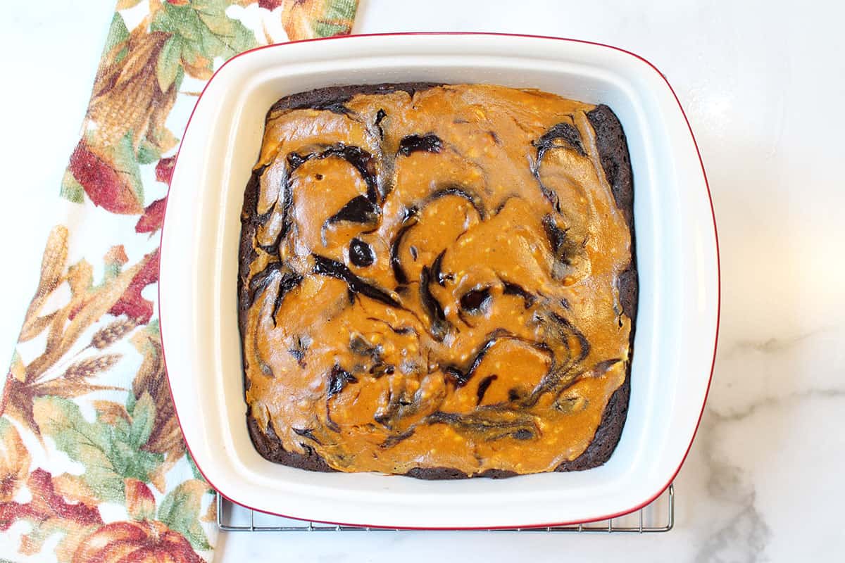 Baked brownies in square baking dish.