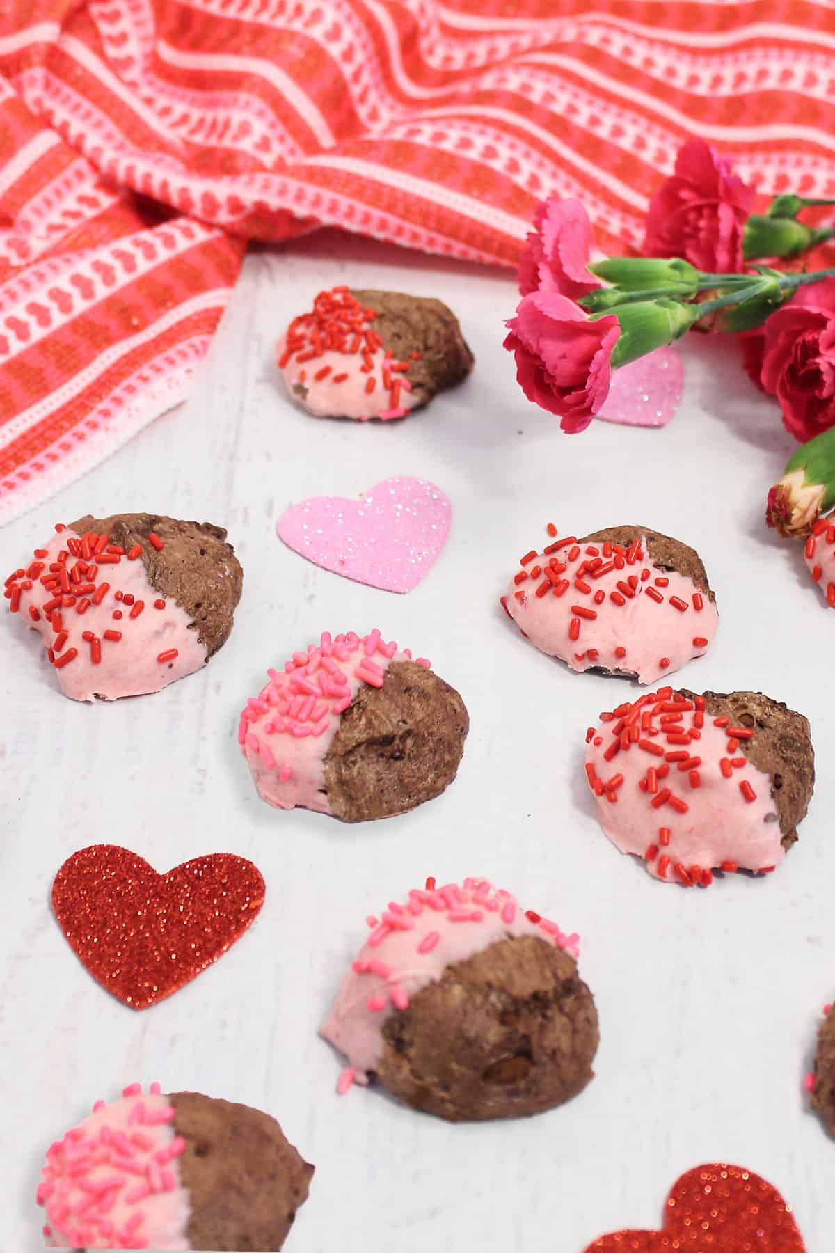 Chocolate meringue cookies scattered on table.