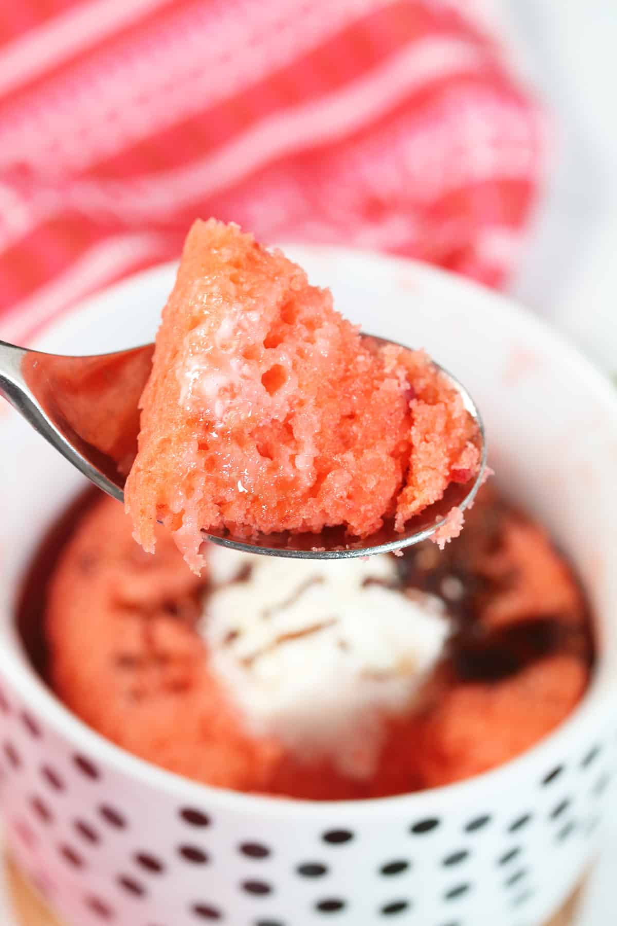 Bite of microwave mug cake over mug.