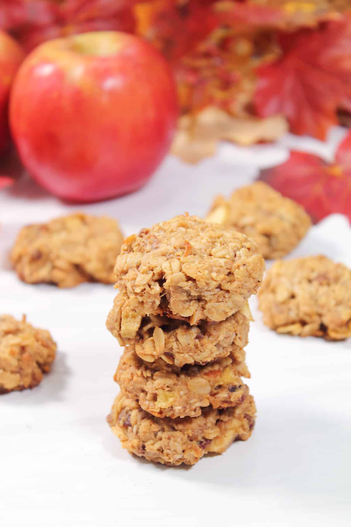 Stack of apple oatmeal cookies with apple.