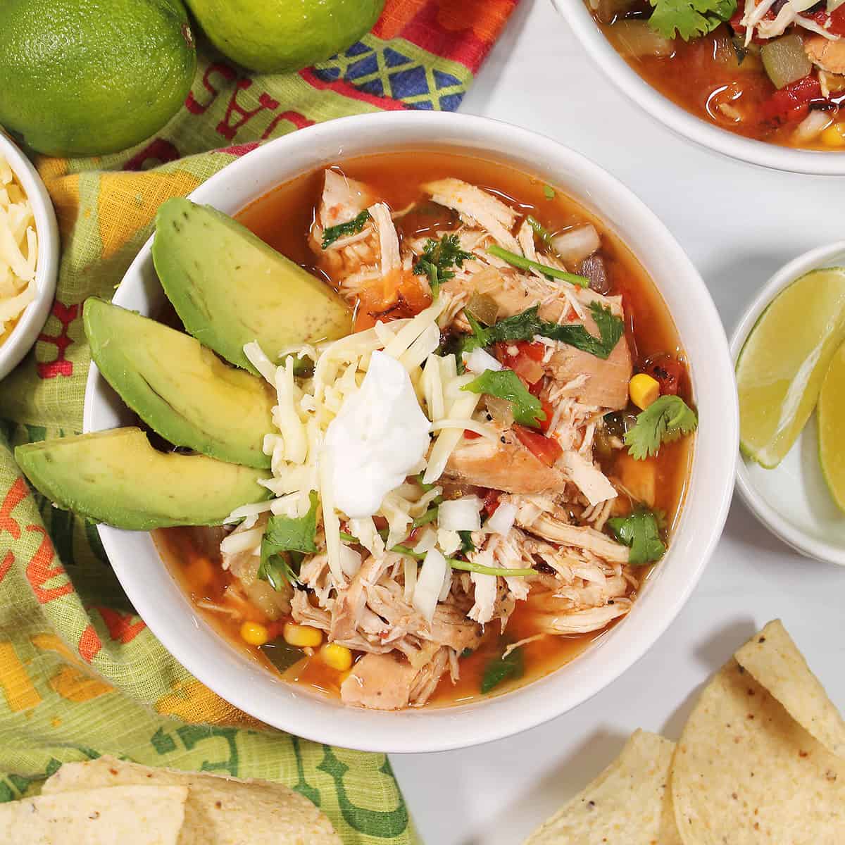 Overhead of garnished bowl of crockpot tortilla soup.