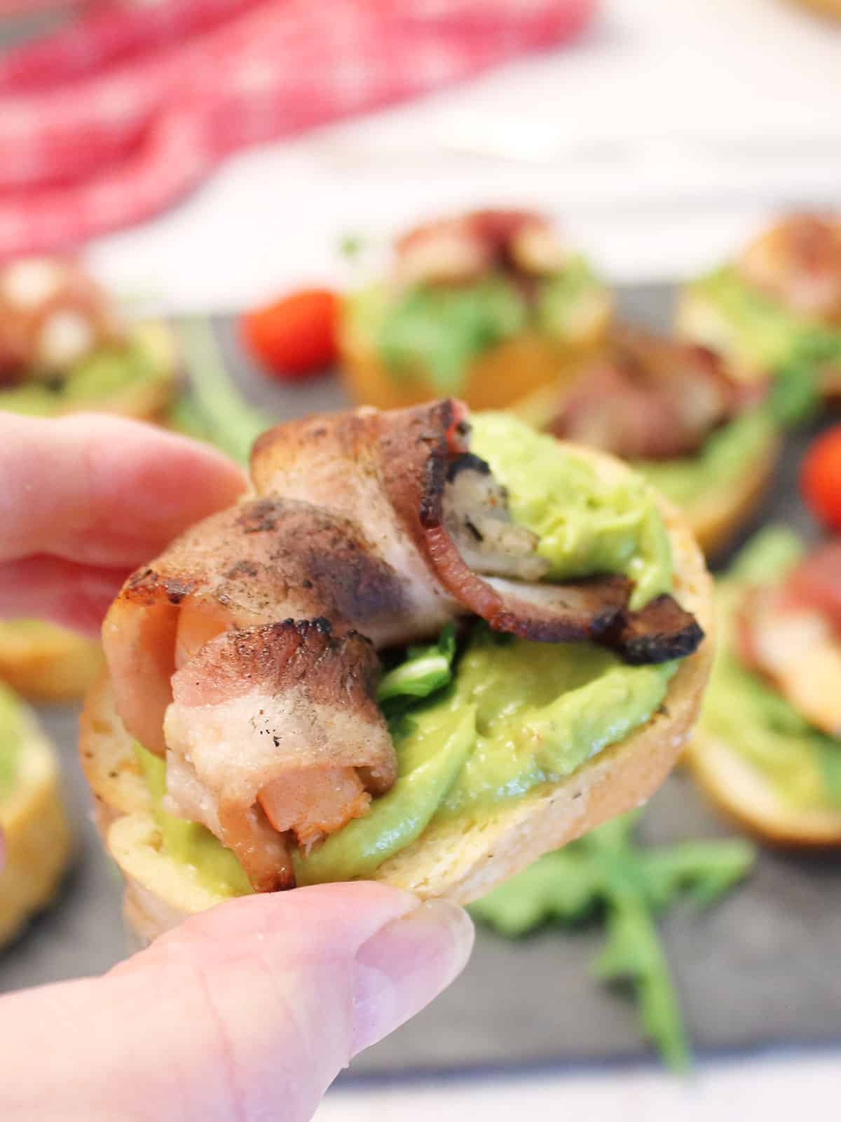 Holding crostini over platter.