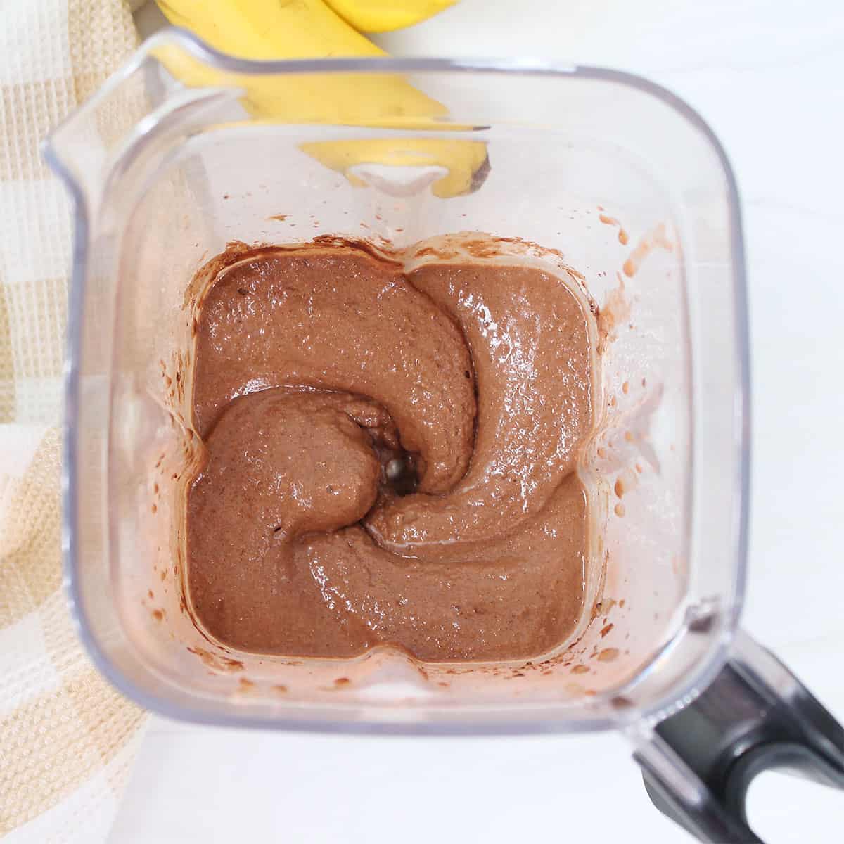 Blended creamy and cool smoothie in blender.