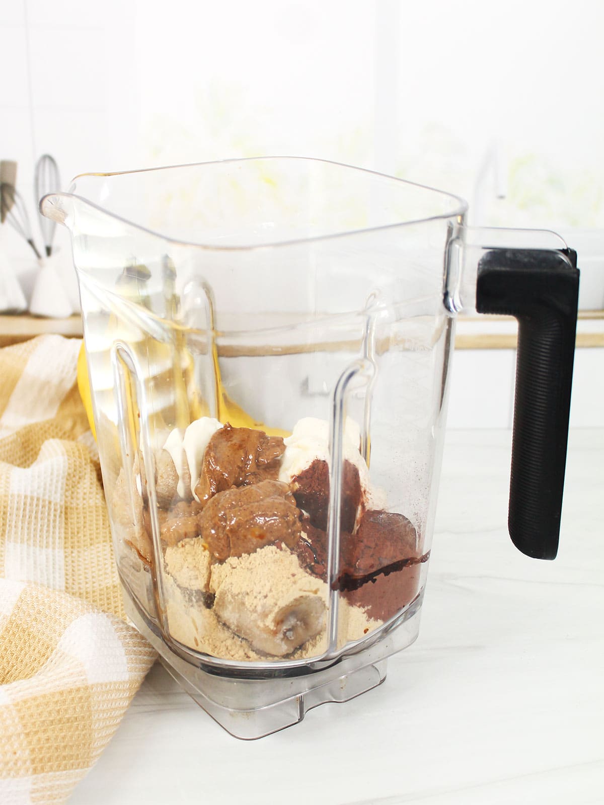 Ingredients for chocolate caramel smoothie in blender.
