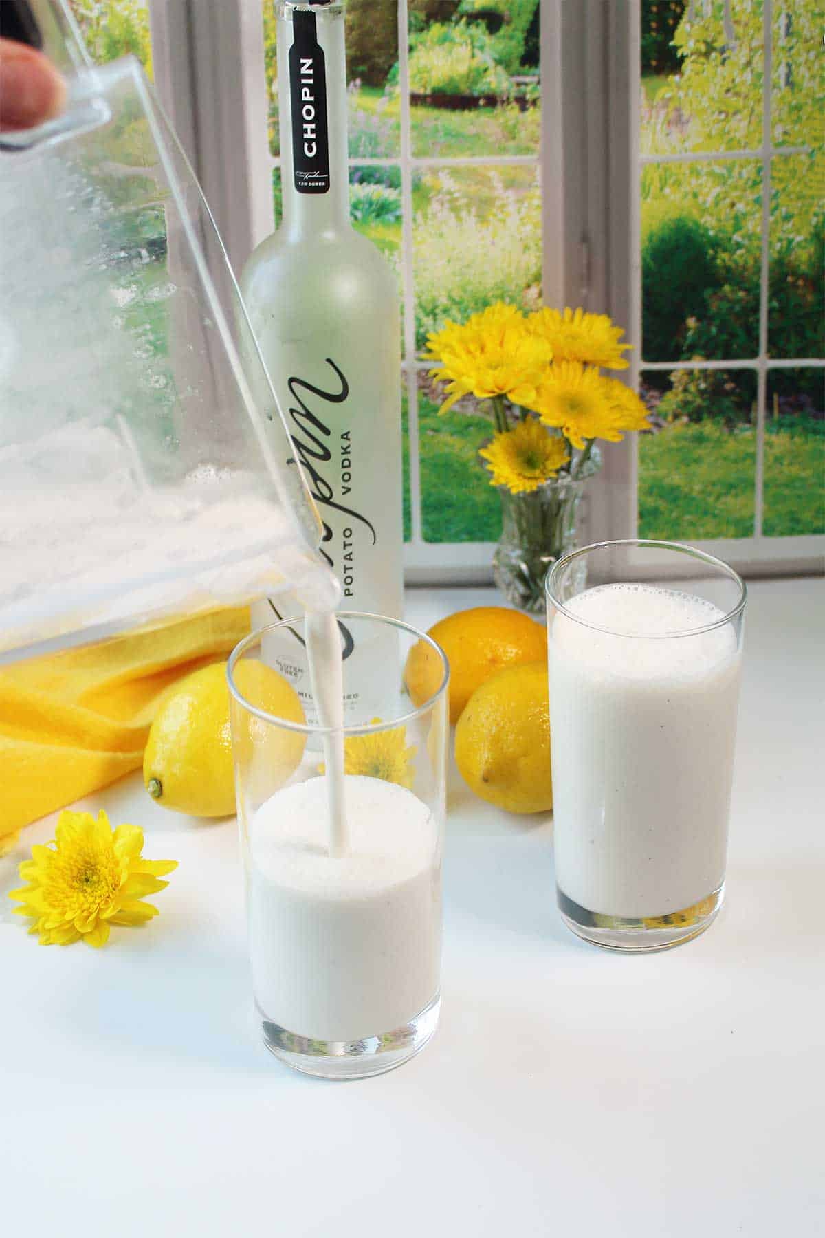 Pouring lemonade drink into glasses.