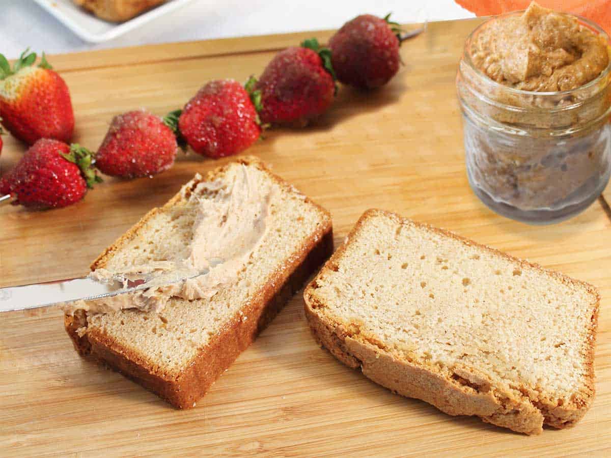 Spreading cinnamon brown sugar butter on pound cake slices.