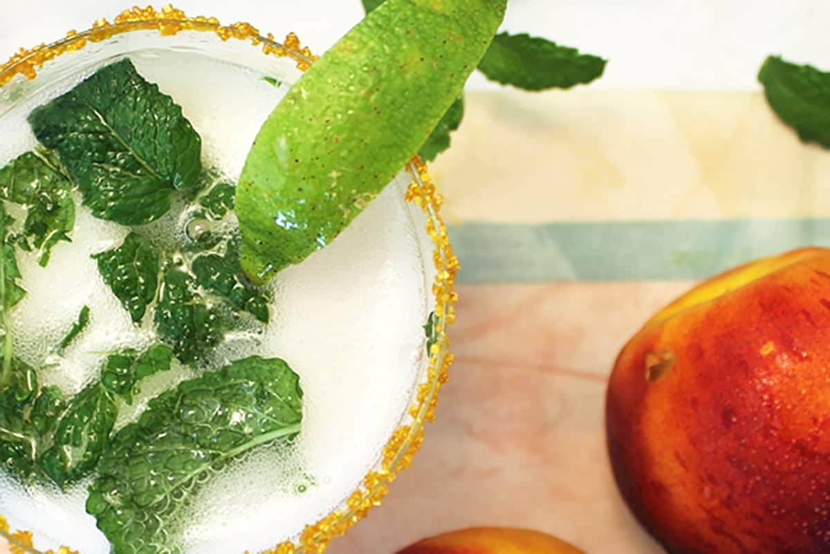 Overhead closeup showing mint leaves and Prosecco effervescence.