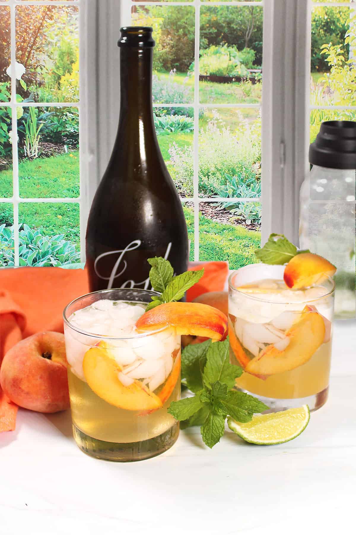 Two cocktails with prosecco bottle.