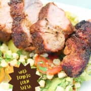 Tex Mex Grilled Pork Tenderloin closeup on platter with tomato corn salsa.