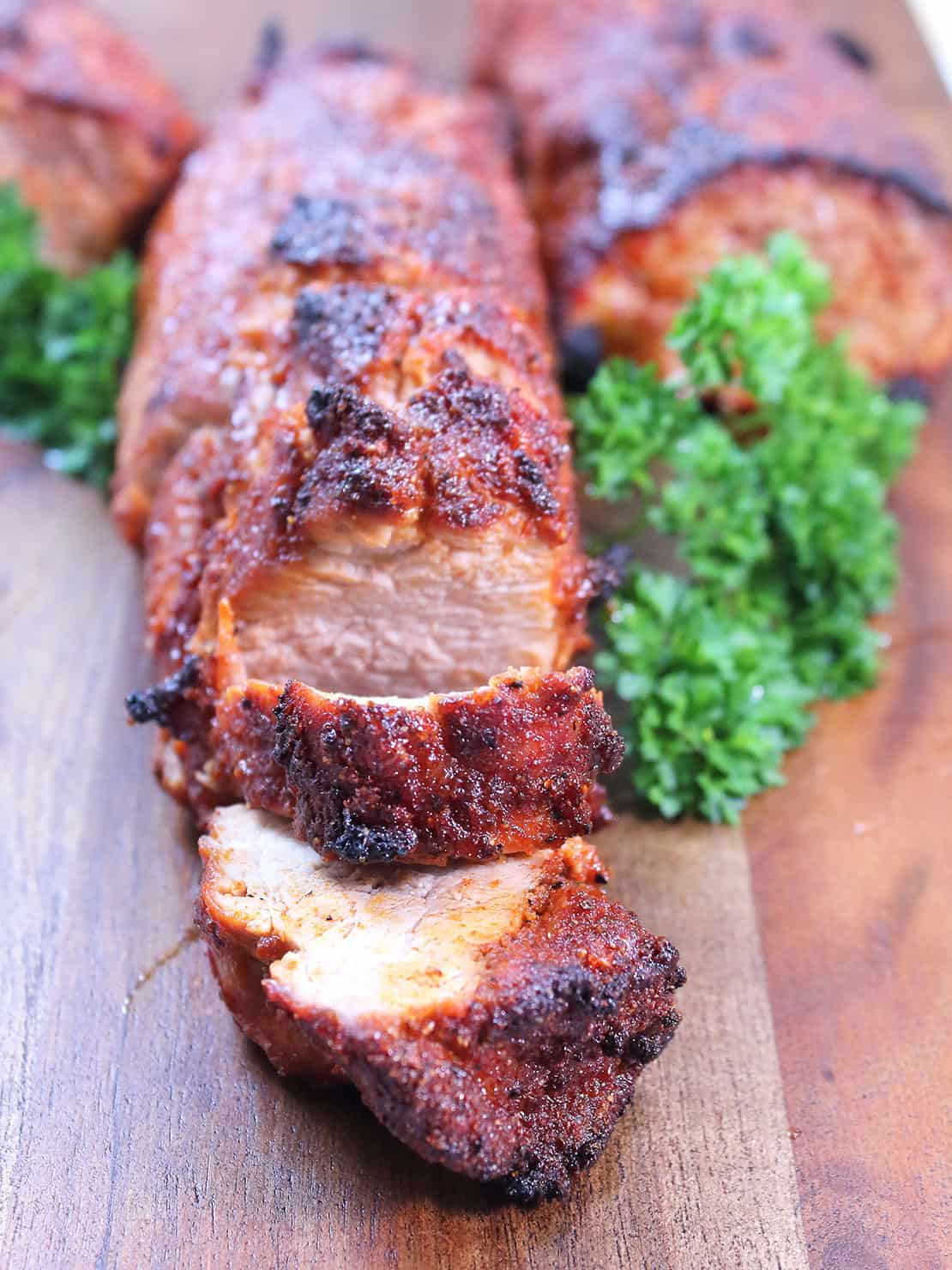 Grilled Tex-Mex pork tenderloin on cutting board.