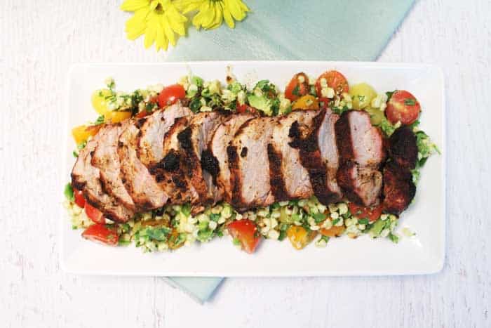 Overhead of Plated Tex Mex Grilled Pork Tenderloins on top of Tomato Corn Salsa.