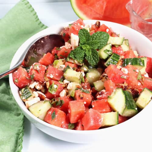 Bowl of Watermelon Cucumber Mint Salad in bowl with spoon.