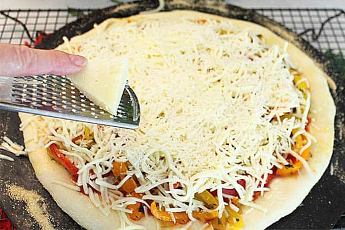 Three Pepper Pizza adding cheese
