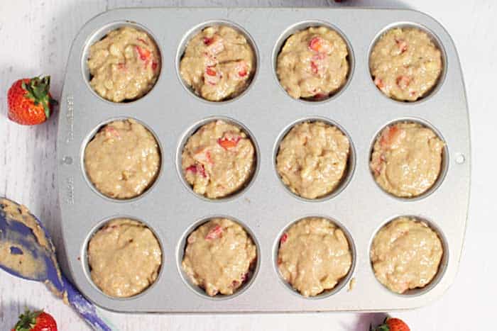 Overhead of filled muffin tin, ready to bake.