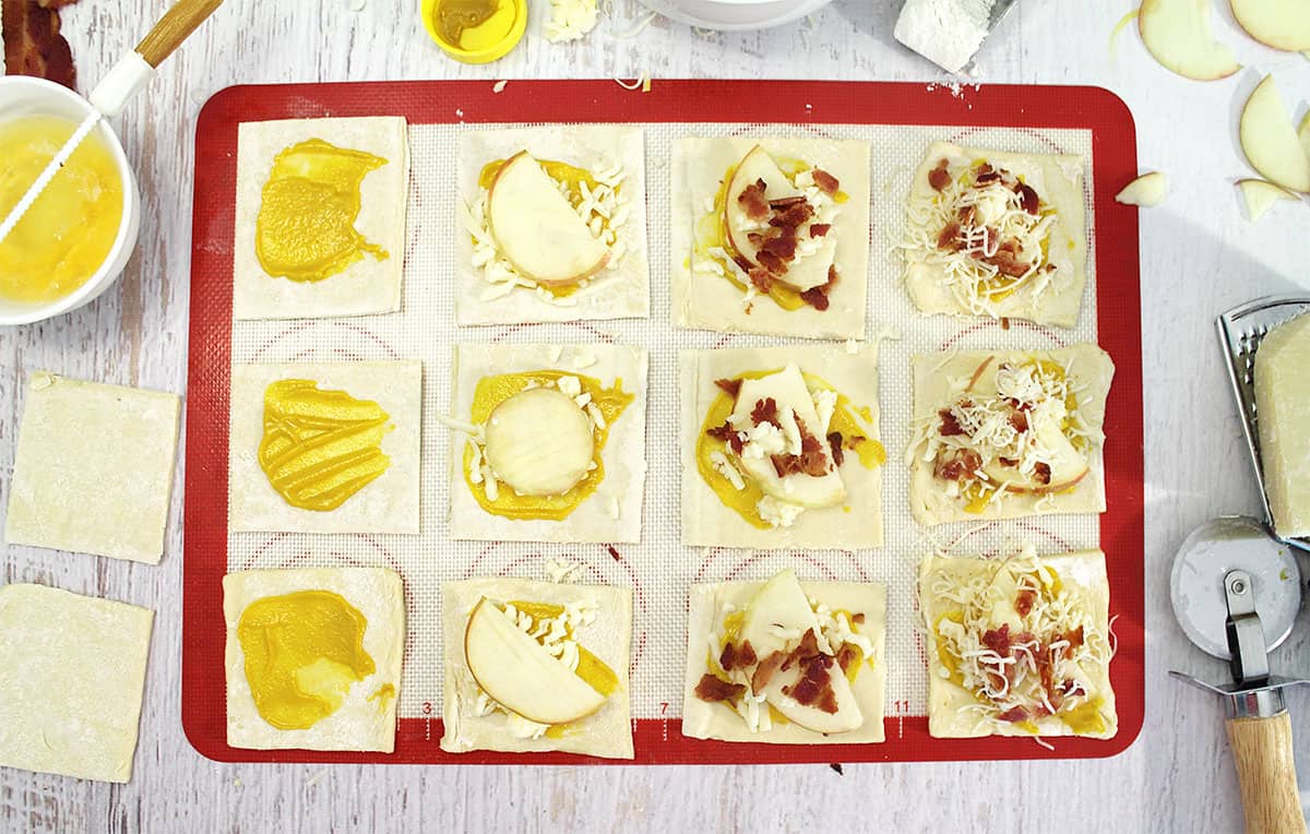 Layering ingredients on puff pastry square.