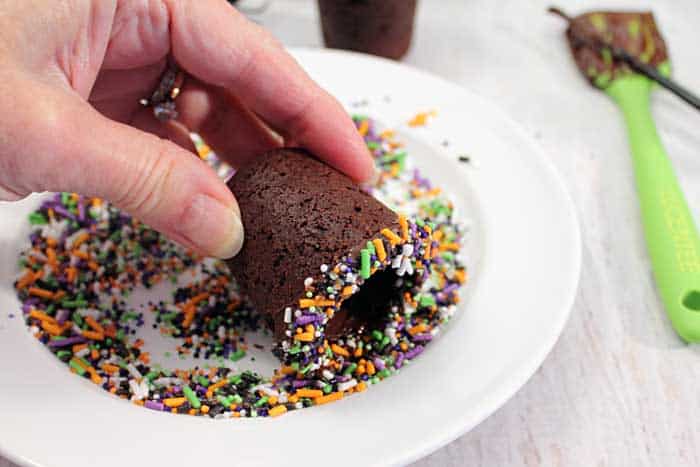 Halloween Chocolate Cherry Cookie shots dipping rim in sprinkles