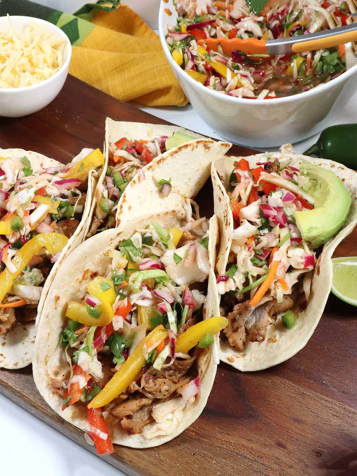 Korean Pork Tacos with slaw on wooden board.