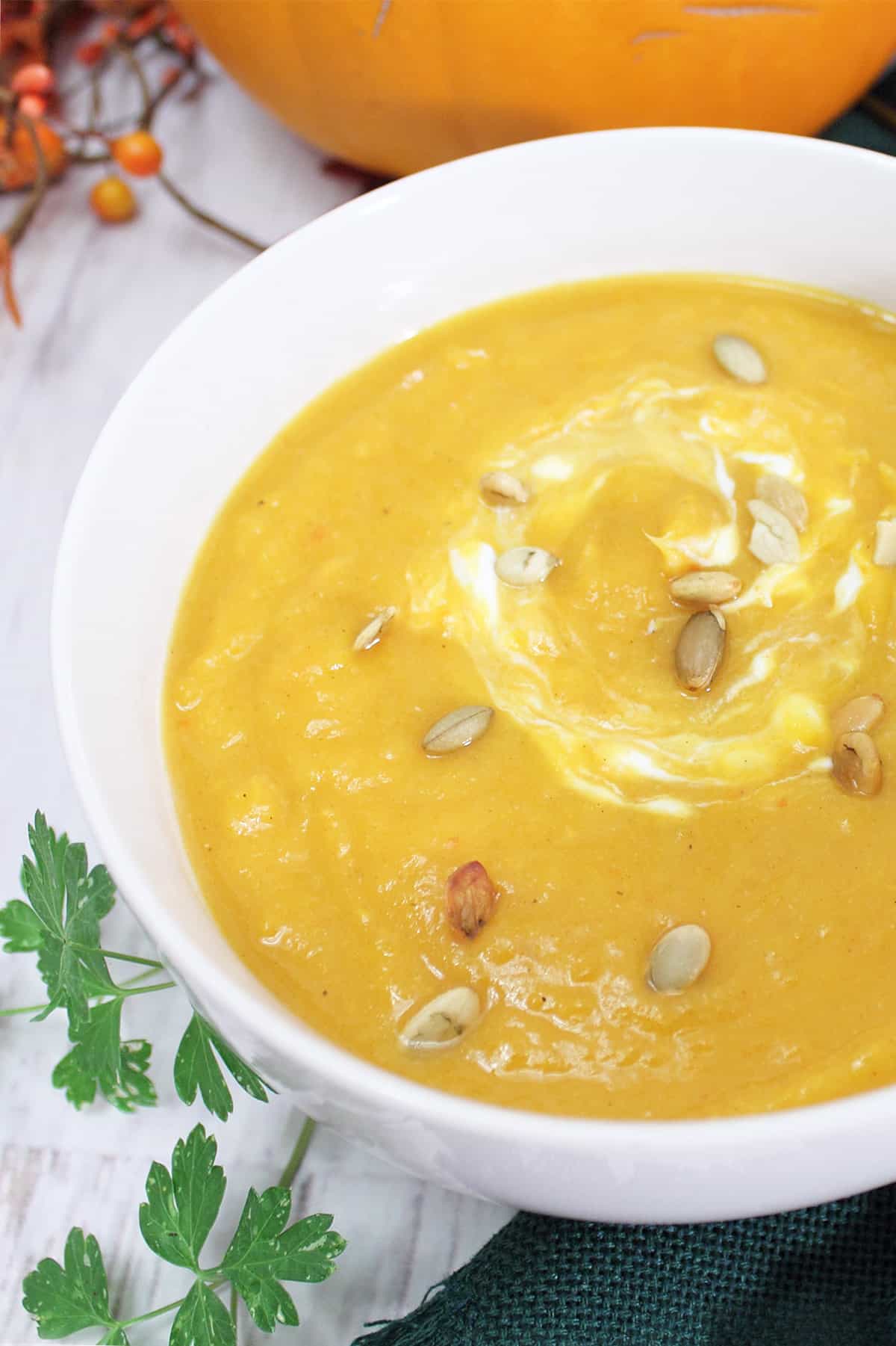 Closeup of bowl of soup with pepitas on top.