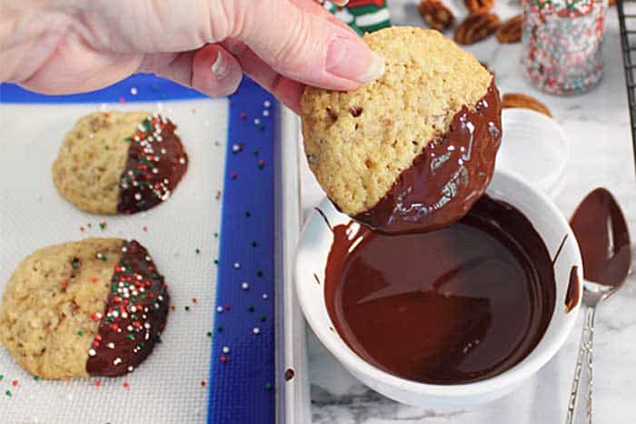 Butter Pecan Ice Cream Cookies dipping in chocolate