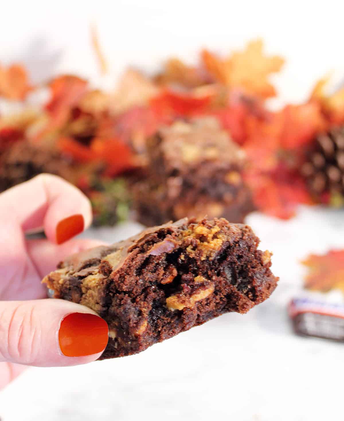 Holding Candy Bar Brownie with bite out of it.