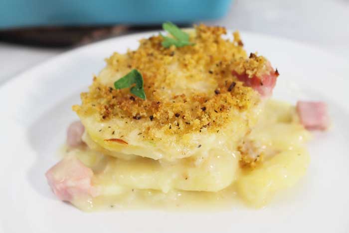 Cheesy Scalloped Potatoes and Ham stack on plate