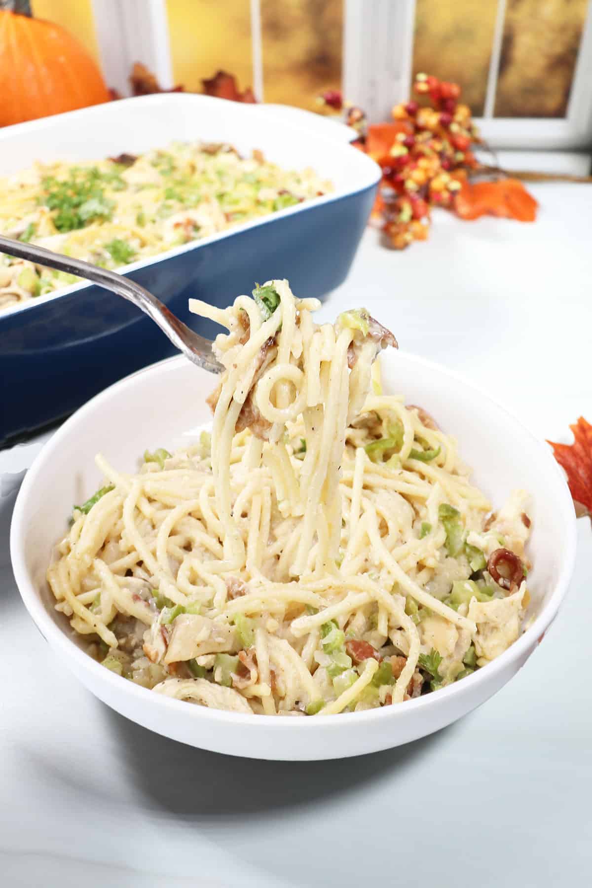 Turkey Tetrazzini in bowl in front of casserole.