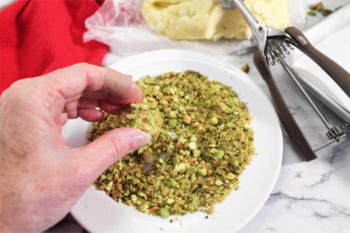 Pistachio Whipped Shortbread Cookies coating in pistachios